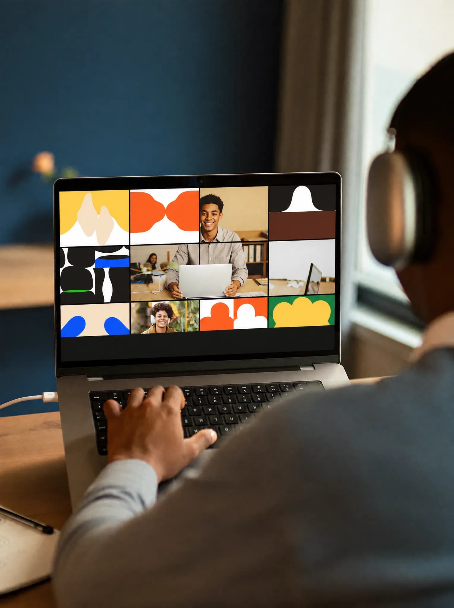 A freelancer on a video call with clients from his home office